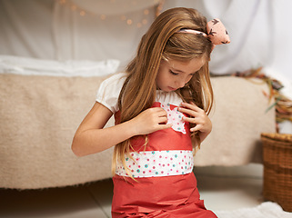Image showing Dress up, clothing and kid with girl crafting, bedroom and home for creative play or fun. Costume, imagine and paper Halloween outfit or arts and craft, clothes and fun for child on floor inside