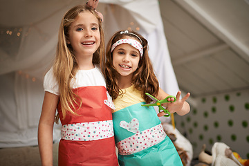 Image showing Style, paper and portrait of children with dress for fun, show or playing together at home. Happy, smile and young girl kids in gift wrap outfit for fashion with bonding in bedroom at house.