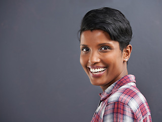 Image showing Happy, portrait and Indian person with smile with gray background at a creative agency office. Hipster, confidence and non binary employee with modern and casual clothing with fashion and style