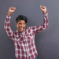 Image showing Excited woman, portrait and dancing with fashion for winning or celebration on a gray studio background. Happy female person, Indian or model with smile for success, style or clothing on mockup space