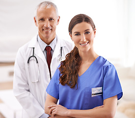 Image showing Doctor, nurse and together in portrait with arms crossed, medical support and wellness in hospital. Medic, mature man and woman in team, smile and healthcare services in clinic with pride for career