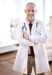 Image showing Portrait, medicine and doctor with arms crossed in hospital for support, services and wellness. Healthcare, lens flare and happy mature medical professional for confident, help and treatment