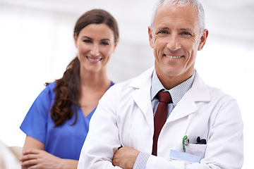 Image showing Doctor, nurse and partnership in portrait with arms crossed, medical support or wellness at hospital. Medic, mature man and woman in team, smile or healthcare services in clinic with pride for career