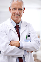 Image showing Healthcare, portrait and medical professional with arms crossed in hospital for support, services and wellness. Medicine, surgeon and happy mature male doctor for confident, smile and treatment