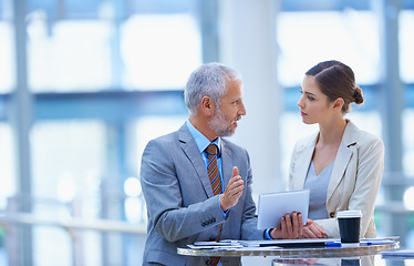 Image showing Businesspeople, colleagues and talking with tablet, conversation and discussion for workshop. Chat, hand gesture and coworkers for conference, professional and corporate male manager with employee