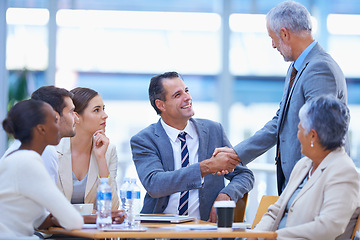 Image showing Coworker, boardroom and handshake with smile for success on deal, contract and teamwork. Diverse, office and happy with business achievement with congratulations as ceo or leader of company.