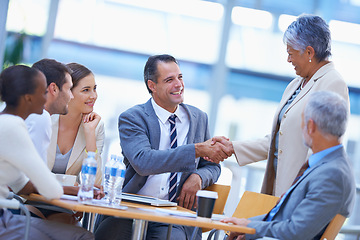 Image showing Coworker, office and handshake with smile for success on deal, teamwork and collaboration. Diverse, boardroom and happy for business achievement with congratulations as ceo or leader of company.