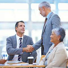 Image showing Coworker, office and handshake with deal for success in business, contract and teamwork. Diverse, boardroom and smile for meeting achievement with congratulations as ceo or leader of company.