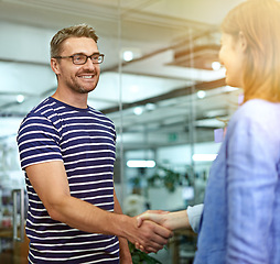 Image showing Man, woman and handshake with smile at startup for welcome, introduction or onboarding with respect. Business people, shaking hands and happy for b2b deal, teamwork or thanks at creative media agency