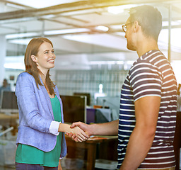 Image showing Business people, shaking hands and smile for interview or agreement, thank you and partnership in recruitment. Colleagues, onboarding and introduction in creative agency, deal and negotiation at work