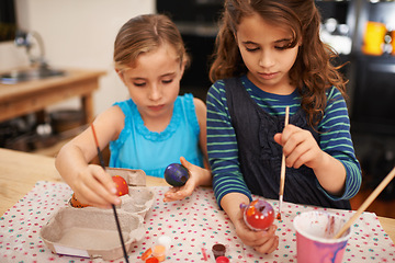 Image showing Painting eggs, sisters and home with girls, creative and hobby with recreation and artistic. Youth, siblings and kids with child development and happiness with tools and colour with activity or relax