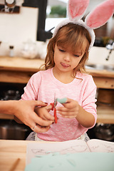 Image showing Little girl, bunny ears and cutting with scissors for arts and crafts, class project or decor. Closeup of child or kid with pattern, outline or paper shape in artwork for easter holiday at school