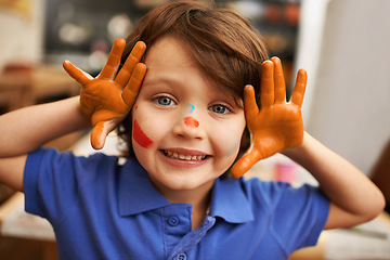 Image showing Happy child, portrait and face paint with color for artwork, craft or creativity at elementary school. Little male person, boy or kid with smile for colorful art, youth or early childhood development