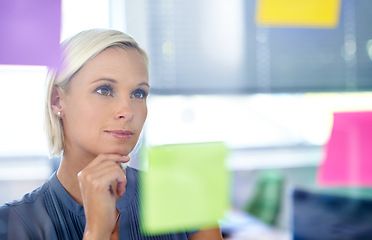 Image showing Woman, glass and wall with thinking, planning and notes with reading, proposal and ideas for development. Person, board and paper with brainstorming process, decision and choice with modern office