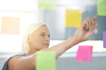 Image showing Woman, glass and board with pointing, ideas and notes for planning, proposal and thinking for development. Person, wall and paper with brainstorming process, decision and choice with modern office