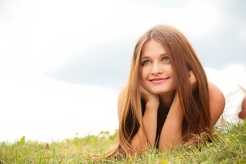 Image showing girl lying on green herb