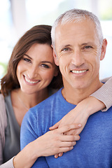 Image showing Couple, portrait and smile in home for hug with support, trust and romance in living room of house. Senior man, woman and happy with face for embrace, affection and healthy relationship in apartment