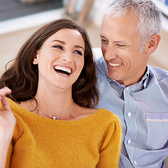 Image showing Couple, happiness and laughing on sofa for love with support, trust and comic joke in living room of house. Senior man, woman and funny in home with embrace, affection and relationship in apartment
