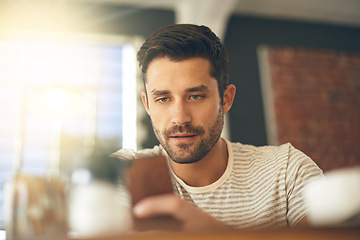 Image showing Man, relax at cafe with smartphone and scroll online for social media, tech and communication. Chat, reading on mobile app or ebook with break at coffee shop, contact and using phone with network