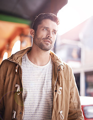 Image showing Man, face and serious in city with fashion outdoor with urban style, trendy outfit and confidence. Male person, walking and commute in Cape Town with wellness, casual clothes and morning travel