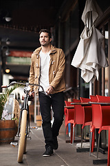 Image showing Sidewalk, cafe and man with bicycle walking in city, thinking and eco friendly transport on commute. Carbon neutral, sustainability and tourist on street for urban journey, travel and male with bike