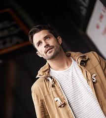Image showing Man, face and serious in town with fashion on low angle with urban style, trendy outfit and confidence. Male person, walking and outdoor view in town with wellness, casual clothes and morning travel
