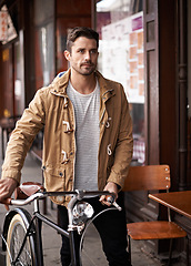 Image showing Sidewalk, cafe and man with bicycle walking in city, thinking and eco friendly transport. Carbon neutral, sustainability and tourist on street for urban journey, morning travel and male with bike