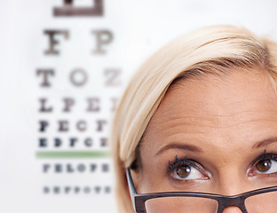 Image showing Woman, glasses and reading of chart for eye test, wellness and frame in closeup. Person or ophthalmologist .looking up, thinking and ideas for optometry, vision and lens check or exam and assessment