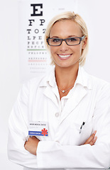 Image showing Woman, glasses and portrait by chart for eye test, wellness and services with arms crossed and confidence. Person or ophthalmologist with optometry for vision and lens check or exam and assessment