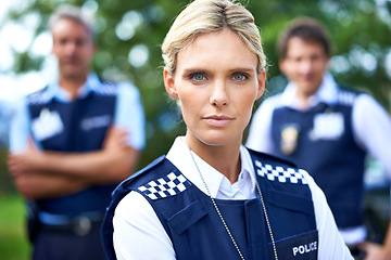 Image showing Security, justice and portrait of police woman outdoors for crime, protection and safety service. Teamwork, collaboration and officer with crossed arms for patrol, law enforcement and surveillance