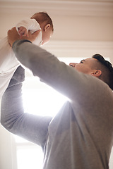 Image showing Father, baby in air and bonding with happiness and love, growth and child development at family home. Man, infant or newborn with smile and dad holding kid for comfort, childhood and parenting
