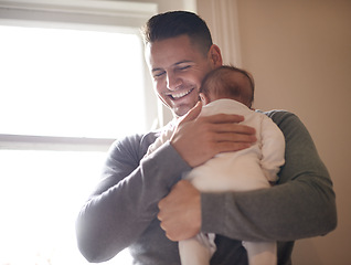 Image showing Father, baby and bonding with happiness and hug, growth and child development with love at family home. Man, infant or newborn with smile and dad holding kid for comfort, childhood and parenting