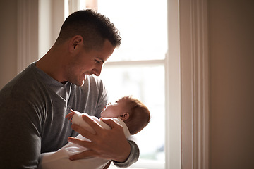 Image showing Father, baby and bonding with love and pride, growth and child development with happiness at family home. Man, infant or newborn with smile and dad holding kid for comfort, childhood and parenting