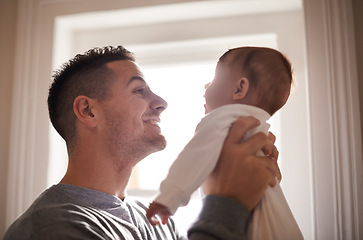 Image showing Father, baby and bonding with smile and love, growth and child development with joy at family home. Man, infant or newborn with happiness and dad holding kid for comfort, childhood and parenting