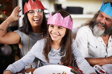 Image showing Christmas hats, grandfather and parents with girl in home for celebration, festival and season event. Happy mom, grandpa and child bonding, relax and laugh for holiday, vacation and festive party