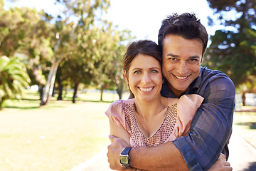 Image showing Couple, portrait and happiness at park with hug for bonding, relax and summer date outdoor in Amsterdam. Man, woman and face with smile in nature with healthy relationship, anniversary and embrace