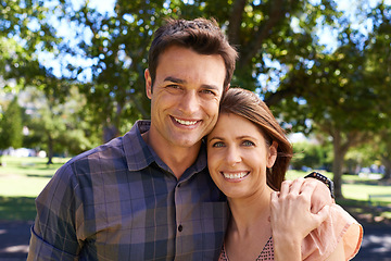 Image showing Couple, portrait and smile at park with hug for bonding, relax and summer love outdoor in Amsterdam. Man, woman and face with happiness in nature with healthy relationship, anniversary and support