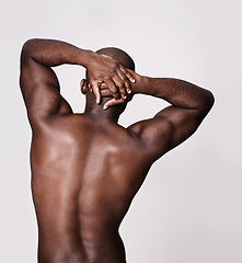 Image showing Back, stretching and man in studio with health, wellness and fitness or exercise on a white background. Bodybuilder, person or model with art deco or muscle, workout and warm up for sports training