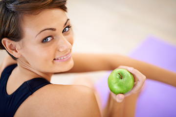 Image showing Portrait, fitness and happy woman with apple in gym for diet, nutrition or wellness with healthy body. Face, smile and person with green fruit and eating organic food with vitamin c for benefits