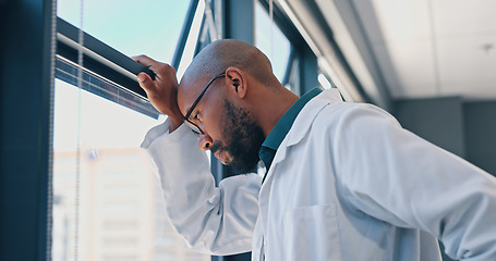 Image showing Doctor, healthcare and thinking at window of hospital with depression, medical decision and burnout. Medicine, african man and thoughtful professional in clinic with mental health, stress and anxiety