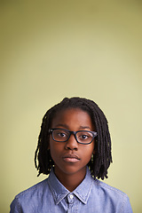 Image showing African child, glasses and portrait in studio for education, learning and knowledge on a green background. Face of creative and smart kid, boy or student with vision for school in studio and mock up