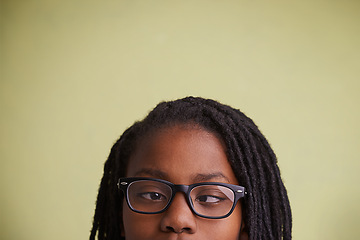 Image showing Glasses, vision and boy kid with cross eyes in studio for eye care, testing or optometry on green background. Medical, help and black teen model with eyeball correcting lens, prescription or solution