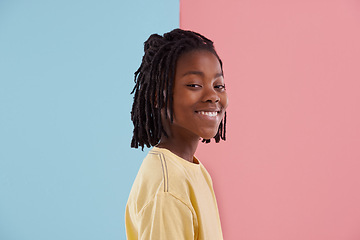 Image showing Happy teenager, portrait and fashion in studio with creative color, style and blue and pink background. Face of young and cool African model or boy in natural hair and casual clothes with pastel