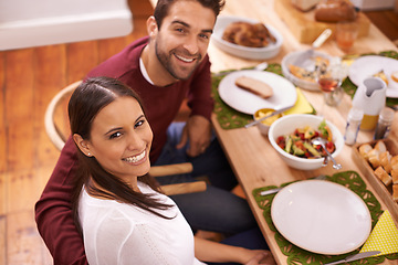Image showing Smile, dinner and portrait of couple at table with family, food, and drinks for celebration in home. Social event, man and woman at thanksgiving lunch together with high angle, relax and holiday