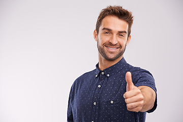 Image showing Support, portrait and man with thumbs up in studio, background and agreement in mockup space. Hand, gesture and happy for success in business with confidence and emoji for ok, thank you and yes