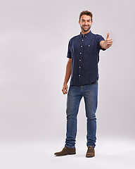 Image showing Young man, portrait and thumbs up in studio for thank you, approval and promotion by grey background. Entrepreneur, smile or face for positive review in satisfaction or agreement hand sign in mockup