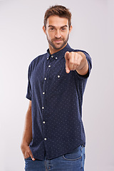 Image showing Young man, portrait and pointing in studio for choice, happy and recruitment by grey background. Hr consultant, smile face and opportunity or yes for decision, vote and positive review for winner