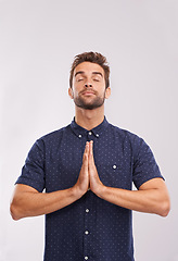 Image showing Young man, studio and hands together in prayer, trust and hope in religion by grey background. Entrepreneur, gratitude or asking god for direction or blessing, guidance or worship in christian faith