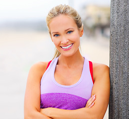 Image showing Outdoor, portrait or woman with arms crossed for fitness training, exercise or workout in Athens, Greece. Confident lady, happy or sports athlete with smile ready for practice for wellness or running