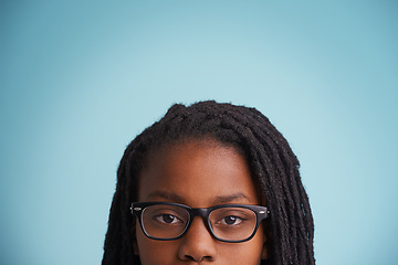 Image showing Vision, glasses or black kid in studio for eye care, wellness or optometry on blue background. Frame, mockup or closeup of African teen male model with eyesight, prescription or ophthalmology testing